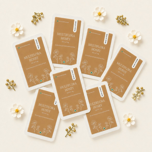 Multiple packages of Multiflora Honey on a light background with flowers and leaves.