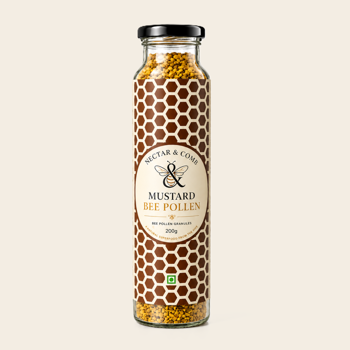 A tall glass jar of Nectar & Comb Mustard Bee Pollen granules, featuring a brown and white honeycomb pattern label with a central cream-colored oval logo, topped with a black lid, on a light beige background.