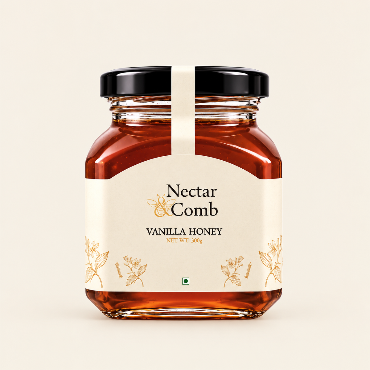 A glass jar of Nectar & Comb Vanilla Honey with a cream-colored label and a black lid, set against a solid off-white background.